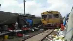 Train Drives Through A Bangkok Market