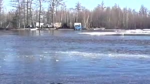 Semi truck crosses flooded street