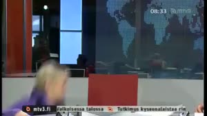 Finnish Newsreader falls off chair.