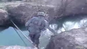 Soldier Takes a Header On River Bank