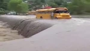 Buses Cross Flooded Bridge