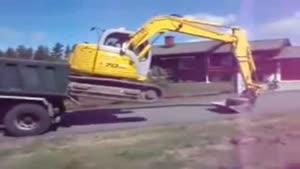 Unloading A Digger From A Truck