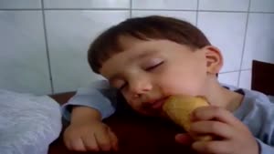 Tired Kid Tries To Eat His Ice Cream