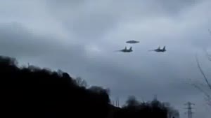 Two Fighter Jets Escorting UFO
