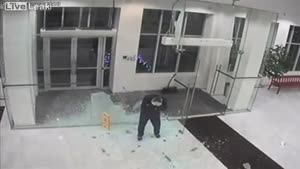 Man Walks Through Glass Entrance