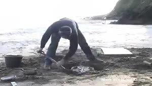 Guy Creates A Stool In The Sand