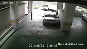 An Asian Woman, A Car And A Parking Garage