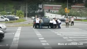 Protesters Lift Up Car