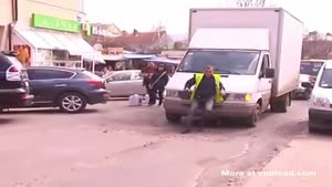 Guy Tries To Stop Moving Truck