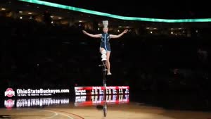 Unicyclist Flips Bowls On Her Head