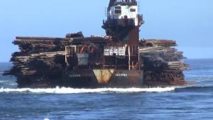 Log Barge Dumping Load Into The Water