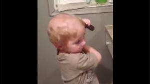 Kid 'Combing' His Hair