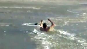 Guy Breaking Ice To Rescue Dog