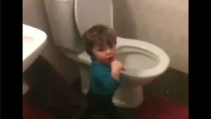 Kid Brushing Teeth On Toilet