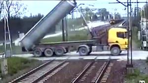 Truck Crosses Railroad With Dumper Up