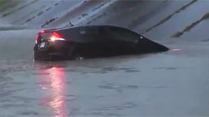 Idiot Drives Into Flooded Road