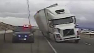 Wind Blows Truck On Police Car