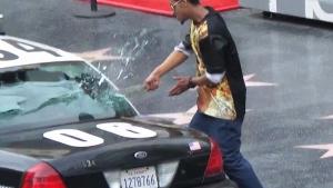 Crazy Man Smashing Windows Of Police Car
