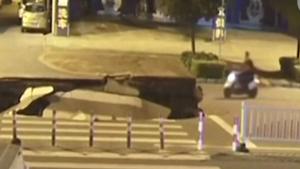 Man On Scooter Misses Sinkhole