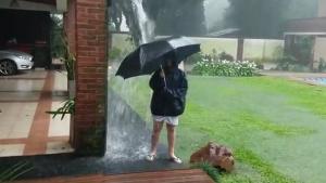 Kid Has Fun In The Pouring Rain