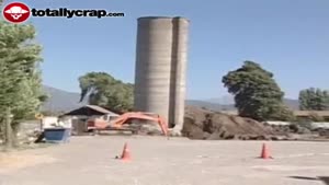 Concrete silo falls on digger