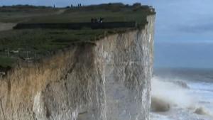 Part Of Cliff Breaks Off Near Oblivious People